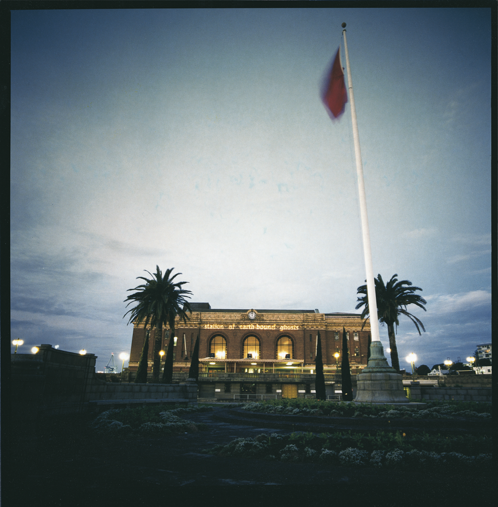 Station of Earth-Bound Ghosts title projected on Auckland Railway Station